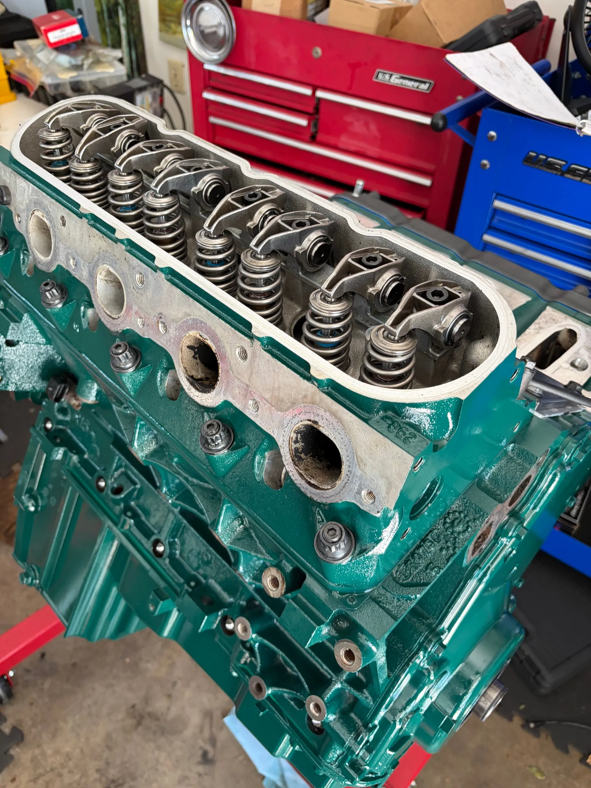 The truck's 4.8-litre V8, painted teal, reassembled on an engine stand